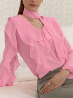 Elegant chiffon blouse with ruffle trim and tie neck detail, featuring a flowy, lightweight fabric and feminine design.