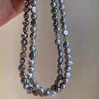 Elegant pearl choker necklace by Shopimist featuring a string of lustrous white pearls on a delicate black ribbon.