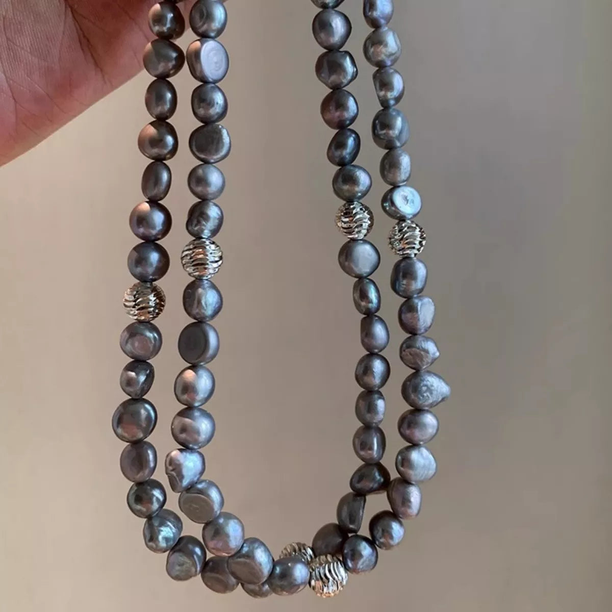 Elegant pearl choker necklace by Shopimist featuring a string of lustrous white pearls on a delicate black ribbon.