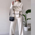 Women’s solid color casual two-piece set by FitiqueFit featuring a loose top and bootcut pants, perfect for comfortable everyday wear.