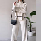 Women’s solid color casual two-piece set by FitiqueFit featuring a loose top and bootcut pants, perfect for comfortable everyday wear.