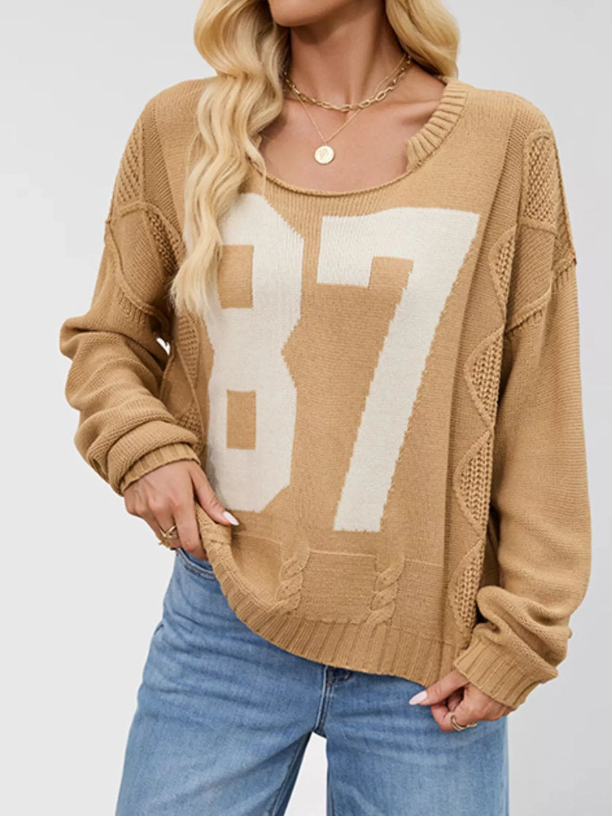 Cable-knit sweater with 78 number design, stylish 78 Number Cable-Knit Sweater from Trendsi, featuring textured knit fabric.