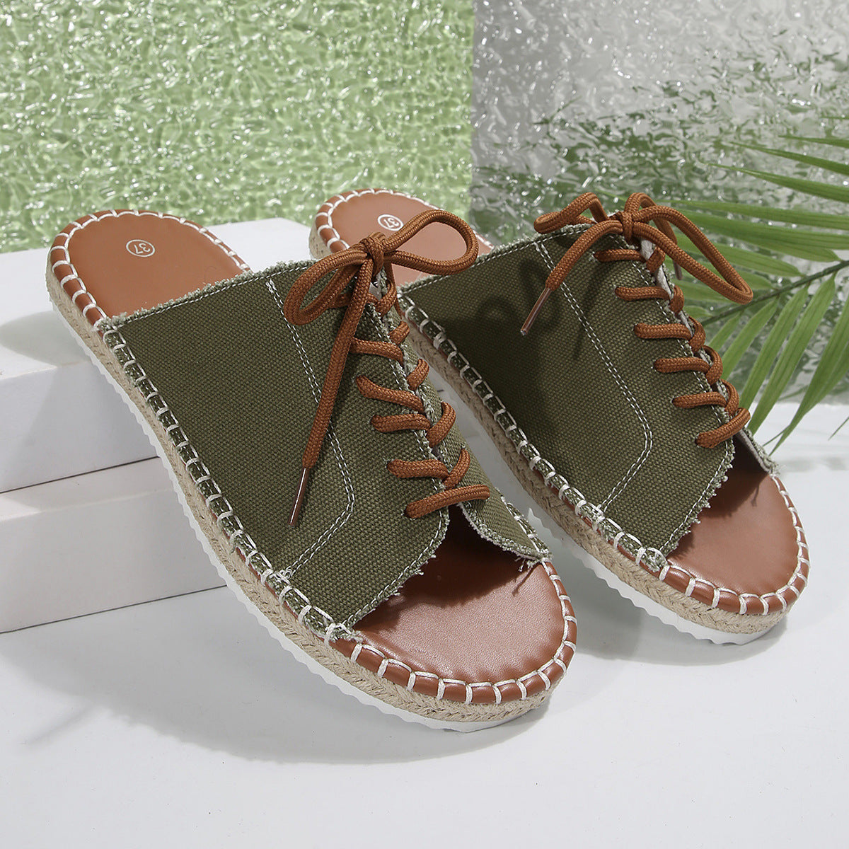 Women's lace-up open toe flat sandals in faux leather with ankle ties, stylish and comfortable for casual summer wear.