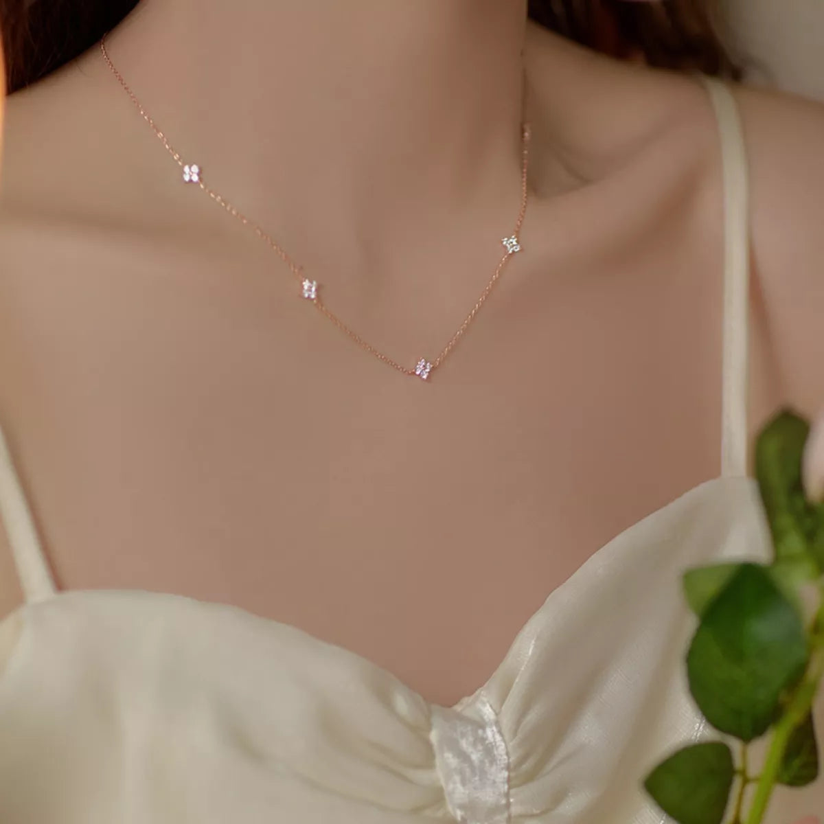 Sterling silver clover charm necklace with delicate chain, featuring a four-leaf clover pendant, crafted by Shopimist.