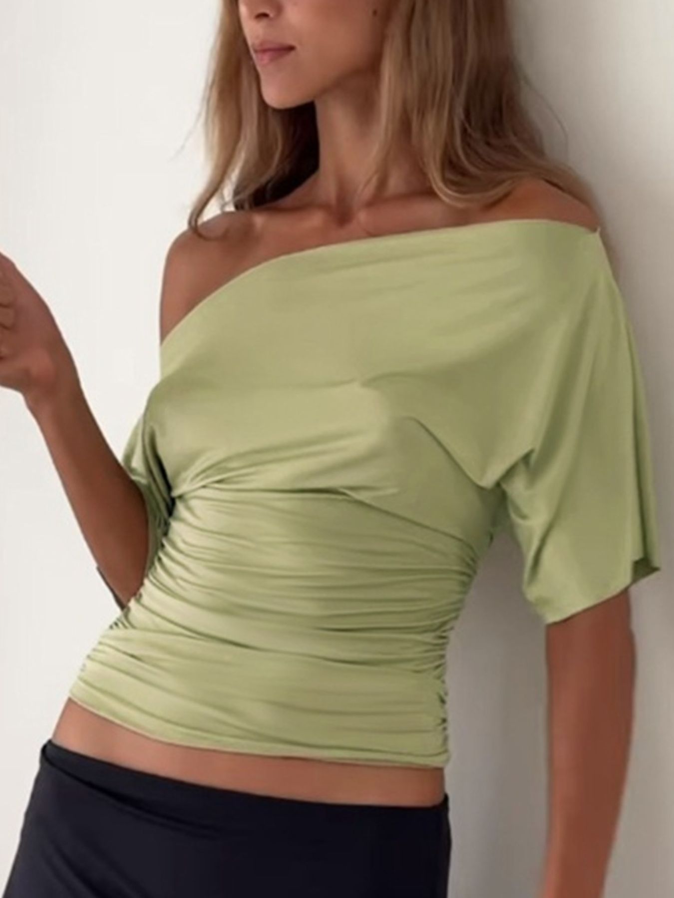 Women's one-shoulder ruched short sleeve T-shirt from Trendsi, featuring a chic, stretchy fit and stylish design.