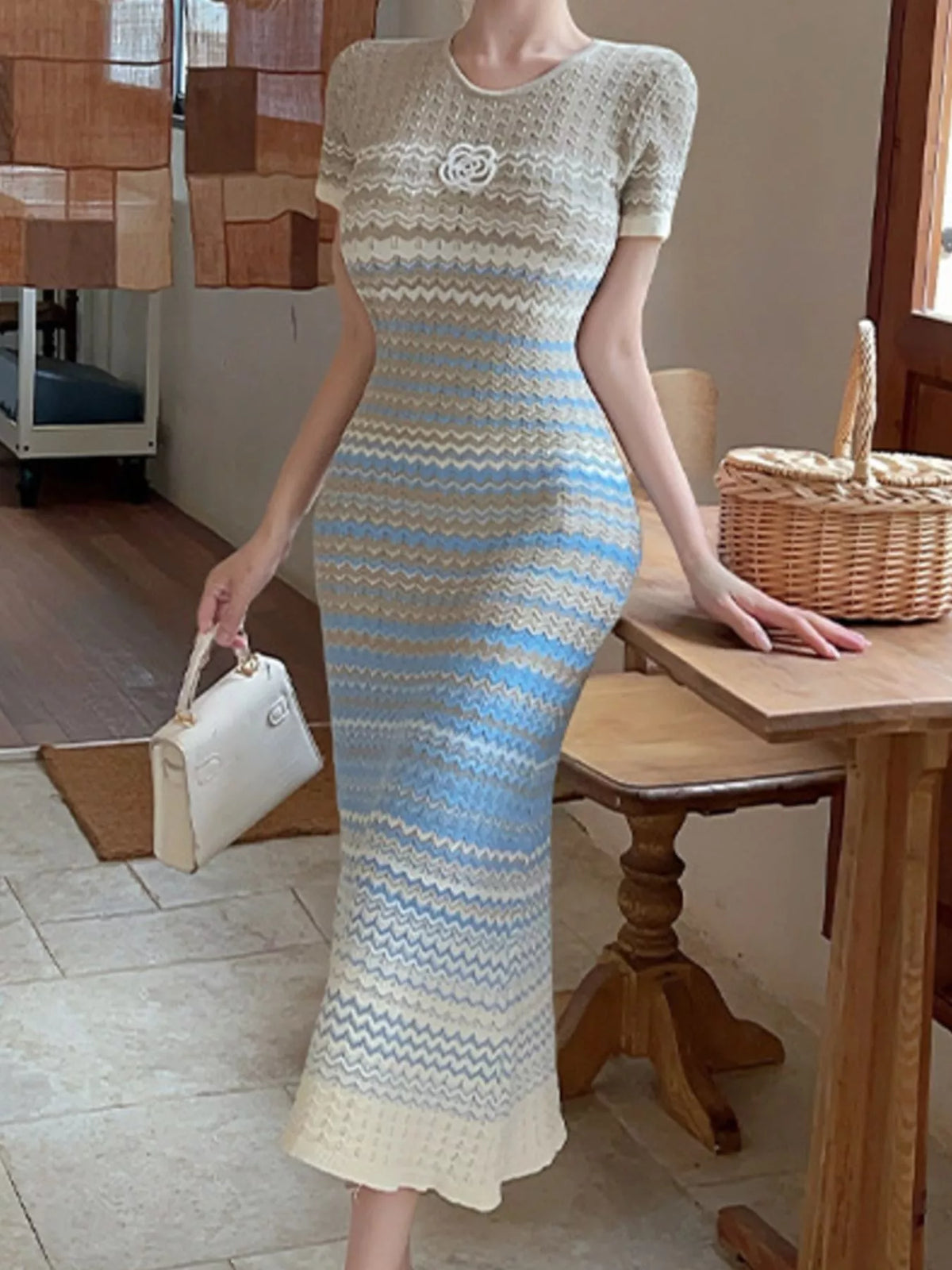 Gradient knit striped short sleeve midi dress by Trendsi, featuring a fitted silhouette and vibrant color transitions.