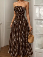 Polka dot strapless maxi dress by Shopimist featuring a flowy silhouette and bold black and white pattern.