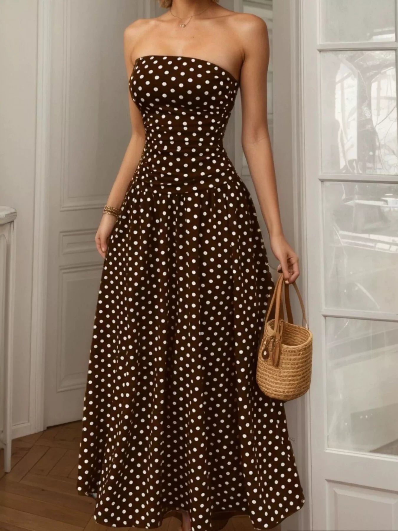 Polka dot strapless maxi dress by Shopimist featuring a flowy silhouette and bold black and white pattern.