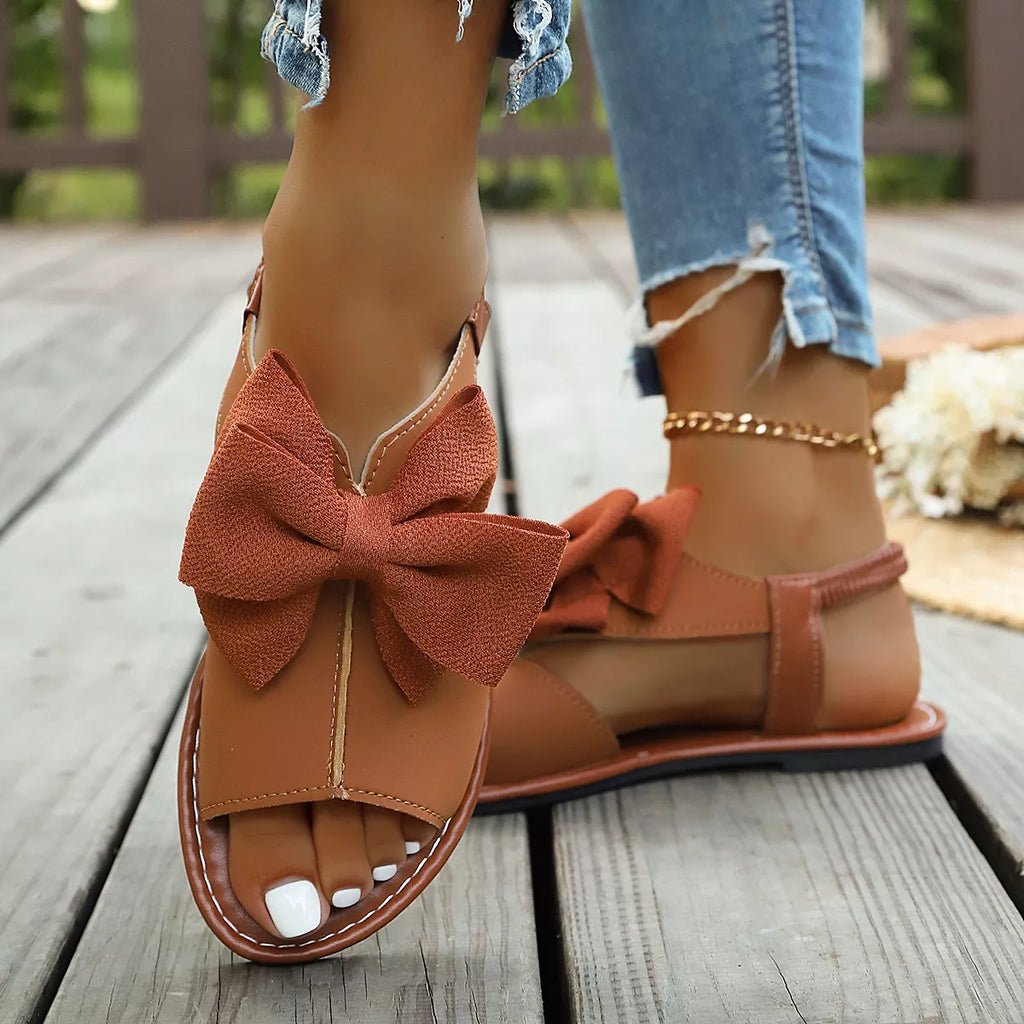 Shopimist open toe bow sandals featuring stylish straps and a comfortable flat sole, perfect for summer casual wear.