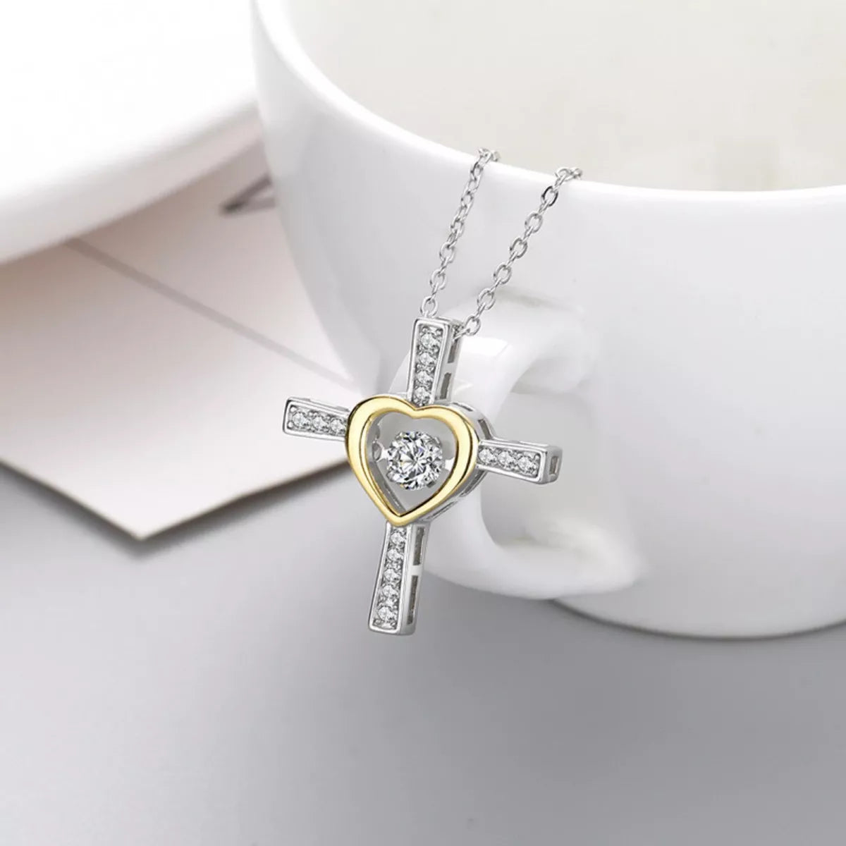 Sterling silver heart cross necklace with a delicate chain, featuring a heart-shaped pendant with a cross design, from Plush Fashion Hub.