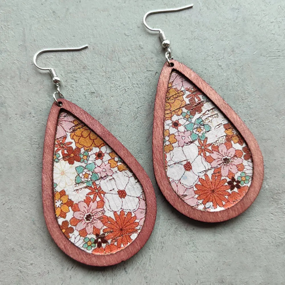 Silver floral wood teardrop earrings with intricate flower patterns, stylish and lightweight jewelry for fashion accessories.