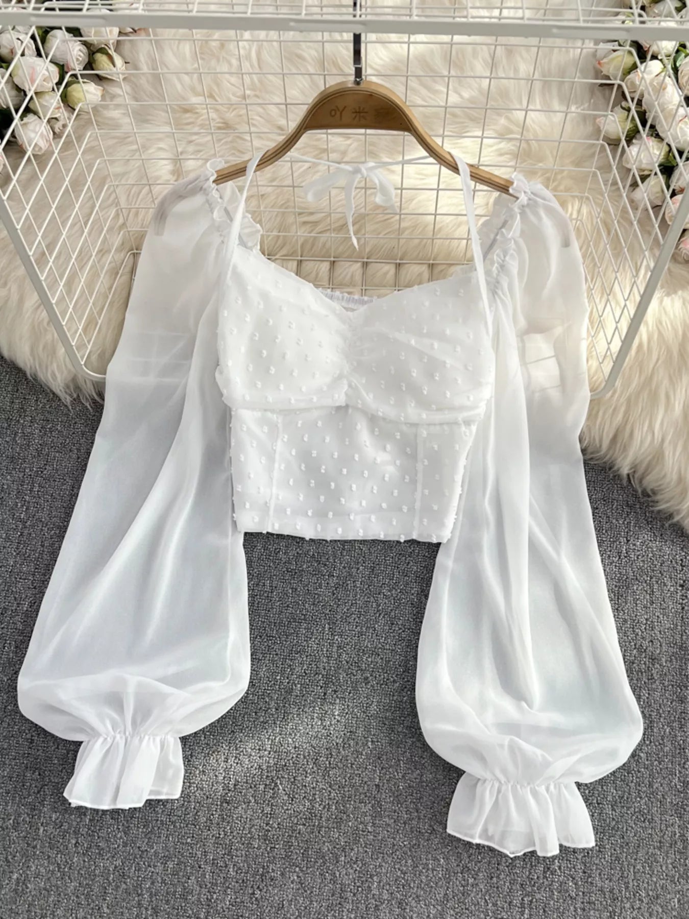 Elegant Swiss Dot ruffled flounce sleeve blouse, long sleeve women's top by Trendsi, featuring delicate fabric and stylish design.