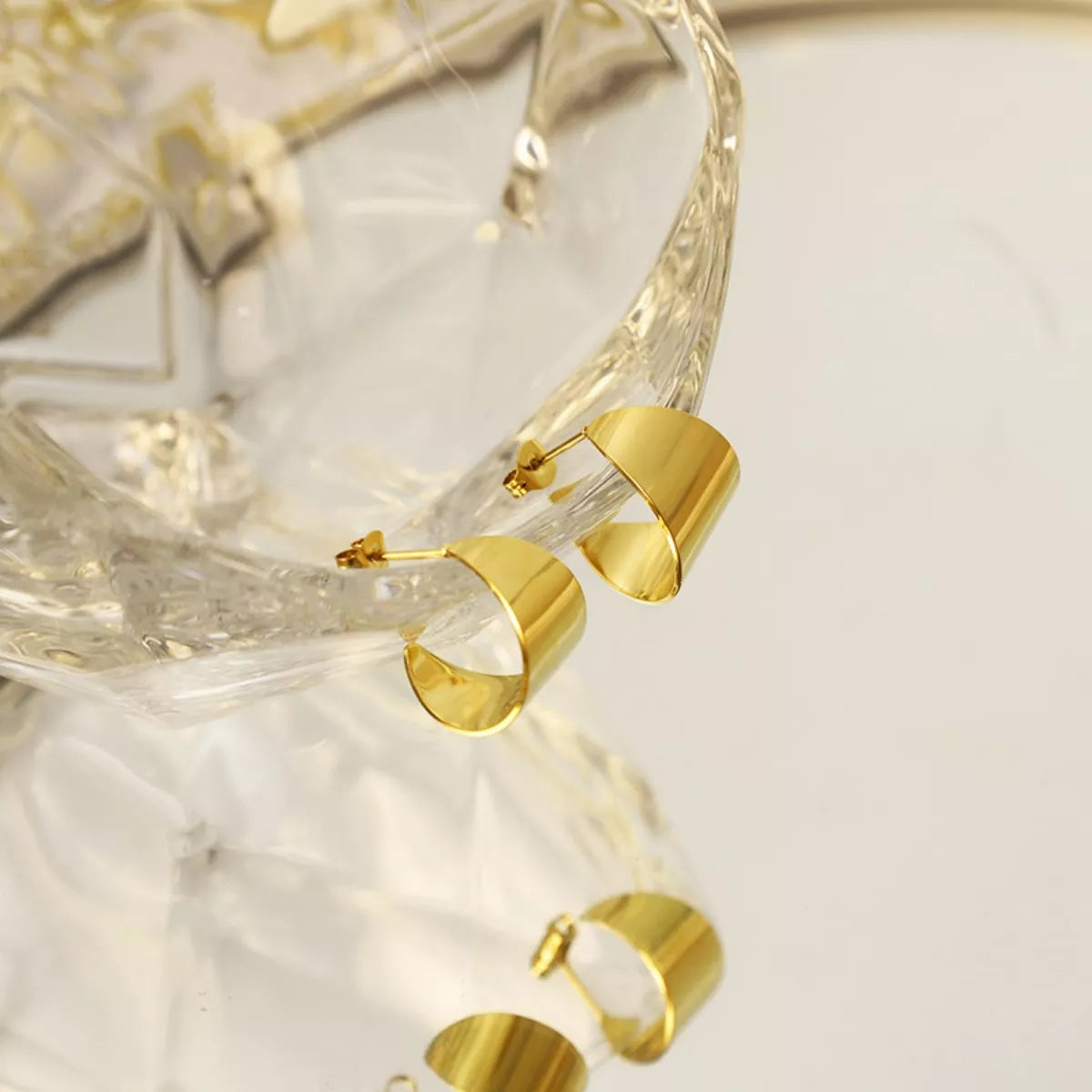 18K gold plated stud earrings with a simple, elegant design, featuring a smooth, shiny finish on white background.