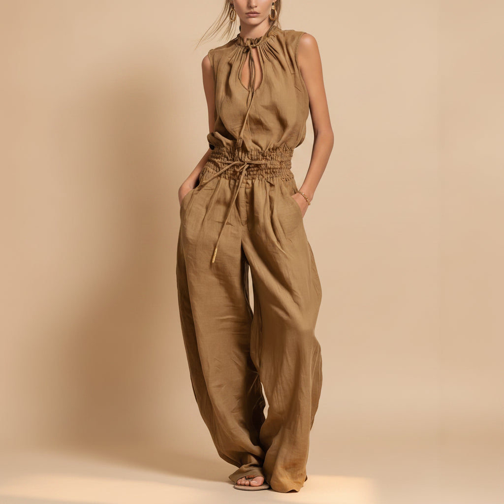 Women's sleeveless high-waist wide-leg pleated jumpsuit by Plush Fashion Hub, shown in casualwear style with a relaxed fit.