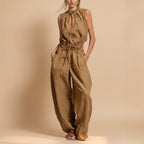 Women's sleeveless high-waist wide-leg pleated jumpsuit by Plush Fashion Hub, shown in casualwear style with a relaxed fit.