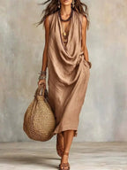Plus size full size cowl neck sleeveless midi dress from Trendsi, featuring a stylish design and comfortable fit.