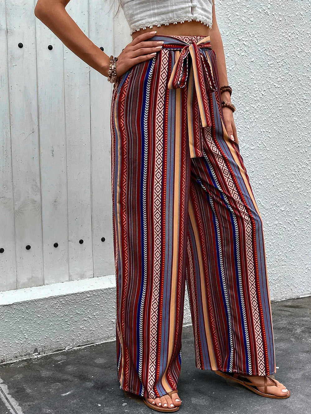 Geometric tied wide leg pants by Plush Fashion Hub featuring bold patterns and a relaxed fit, displayed on a model.
