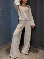 Trendsi zip-up cropped outerwear and pants set, stylish and casual, shown on a model in a modern indoor setting