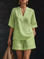 Plus size notched half sleeve top and shorts set by Trendsi, featuring a stylish coordinated outfit in a full size.