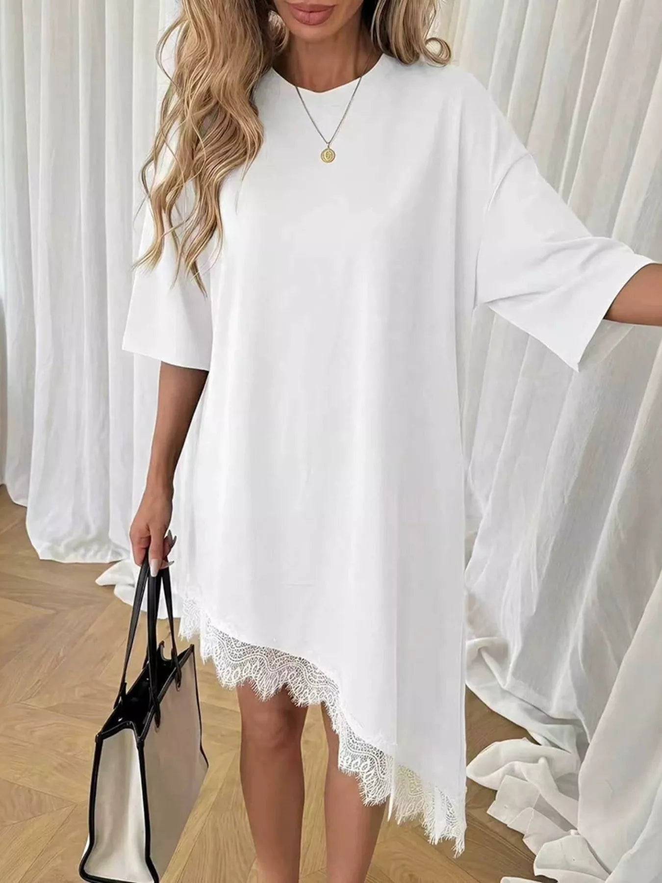 Lace trim asymmetrical hem T-shirt dress by Plush Fashion Hub, featuring a casual fit with decorative lace details and uneven hemline.