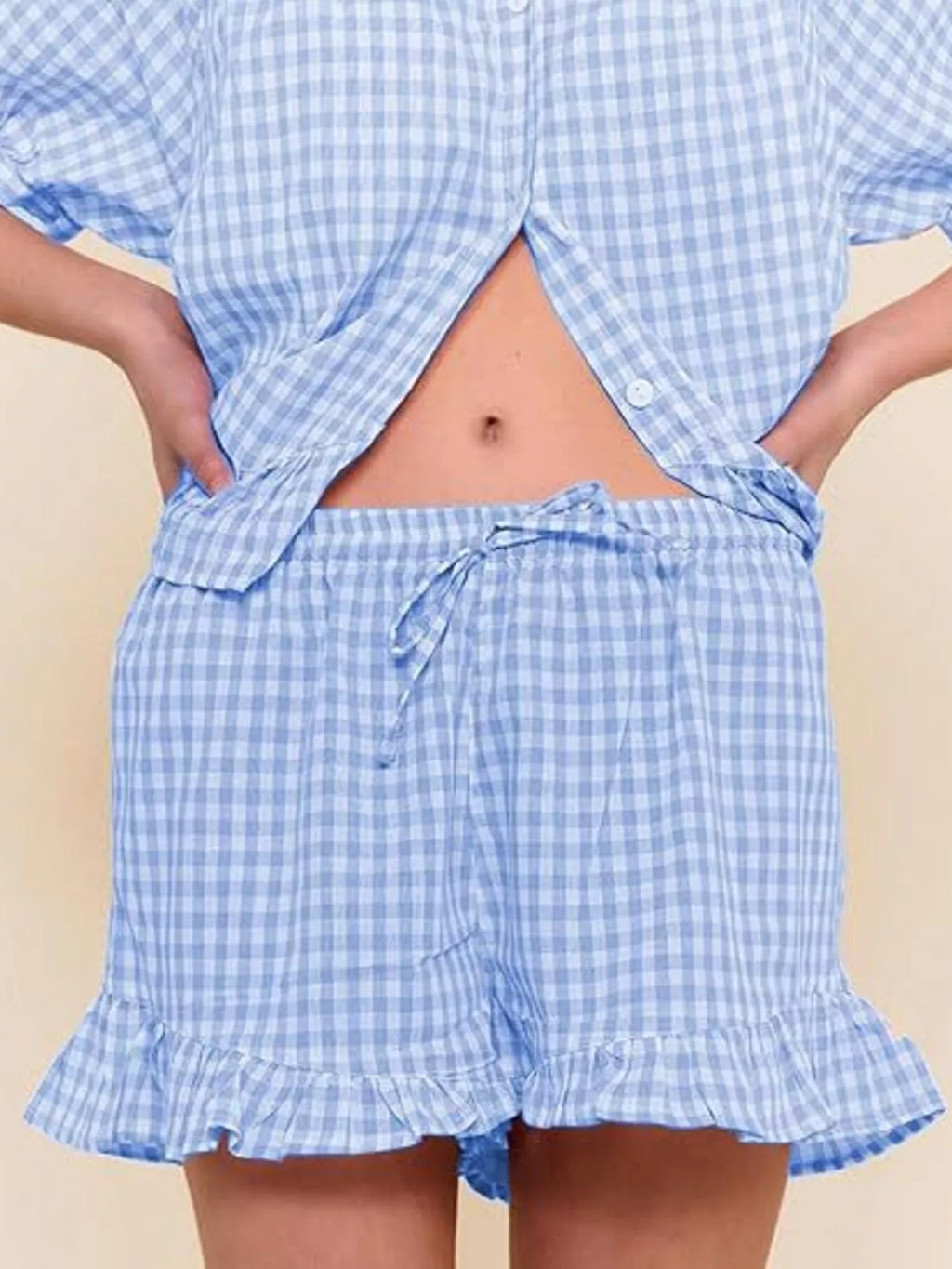 Gingham ruffle trim top and shorts set by Trendsi, featuring a stylish matching outfit with ruffled details on the top and shorts.