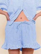 Gingham ruffle trim top and shorts set by Trendsi, featuring a stylish matching outfit with ruffled details on the top and shorts.