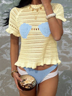 Openwork ruffled hem knit top from Trendsi, showcasing a stylish lightweight knit with ruffled details and openwork pattern.