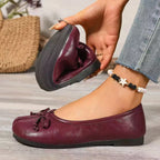 Trendsi Bow Decor Split Toe Slip-On Shoe featuring bow embellishment and sleek design, stylish footwear for casual or dressy wear.