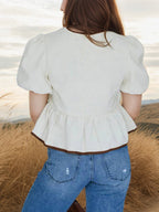 Elegant white tie-front puff sleeve peplum blouse by Trendsi, featuring ruffled sleeves and a fitted waist.