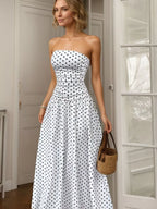 Polka dot strapless maxi dress by Shopimist featuring a flowing silhouette and bold black and white pattern.