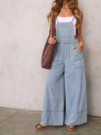 Women's relaxed fit wide leg denim overalls jumpsuit made from comfortable cotton blend, featuring adjustable straps and front pockets.