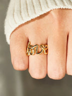 Love 18K gold-plated sterling silver ring with a sleek band and minimalist design, showcasing polished silver and gold accents.