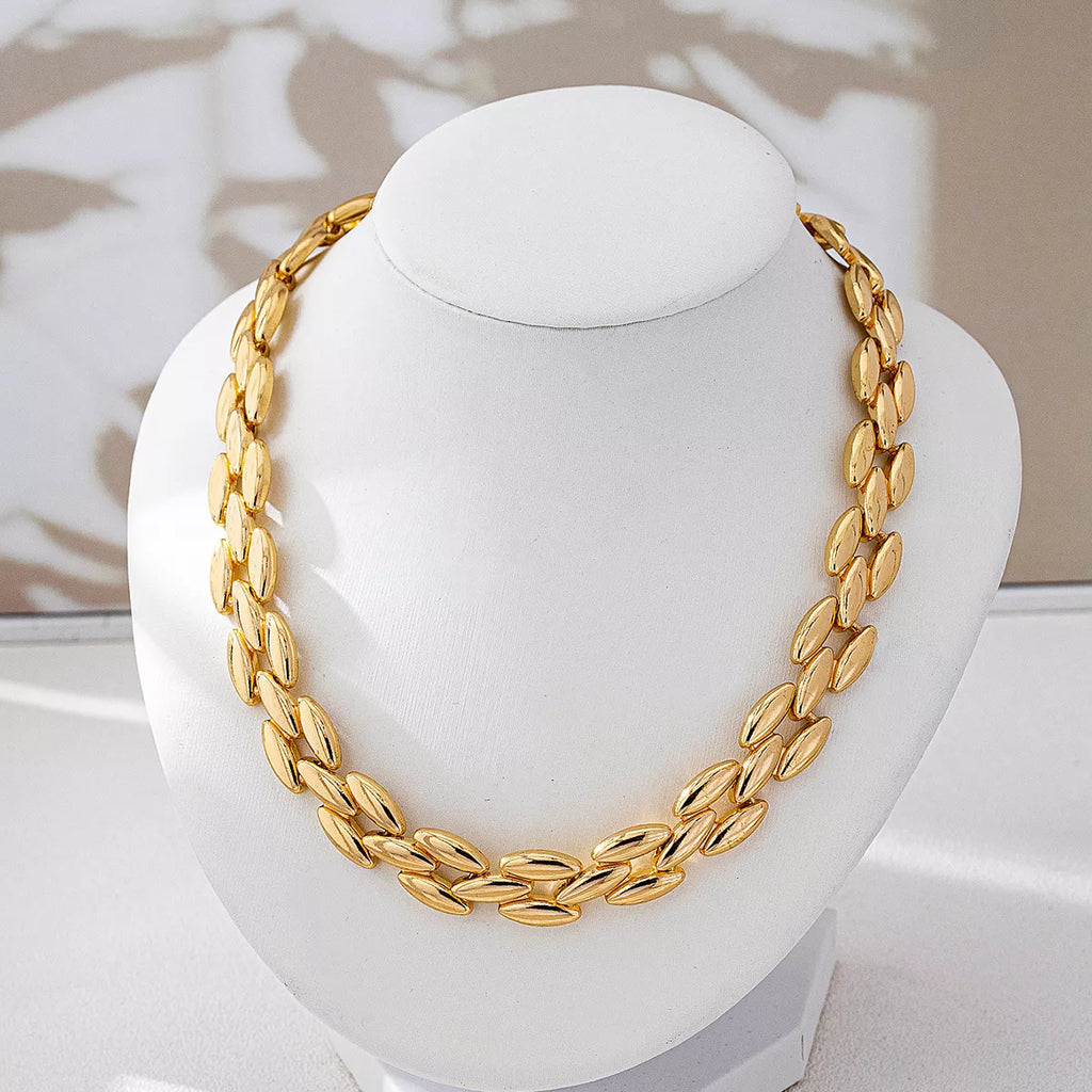18K gold-plated chunky necklace with bold links, styled on a model showcasing its shiny finish and fashionable statement design.