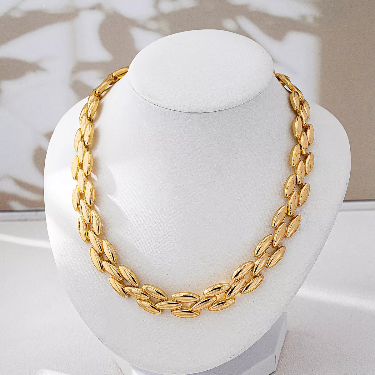 18K gold-plated chunky necklace with bold links, styled on a model showcasing its shiny finish and fashionable statement design.