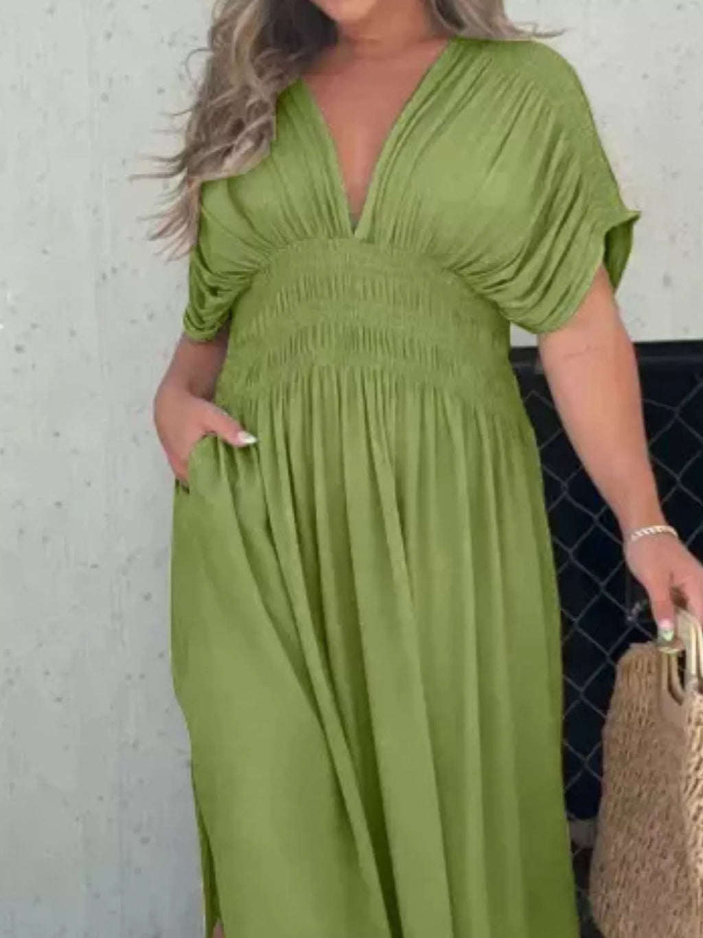 Plus size full-length maxi dress with slit, V-neck, and smocked waist by Trendsi, shown in a flowing fabric design.