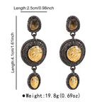 Vintage-inspired dangle earrings with gold accents, featuring intricate design and elegant craftsmanship, by Shopimist.