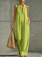 Plus size full-length halter neck jumpsuit with wide-leg design from Trendsi, shown in a full-body view.