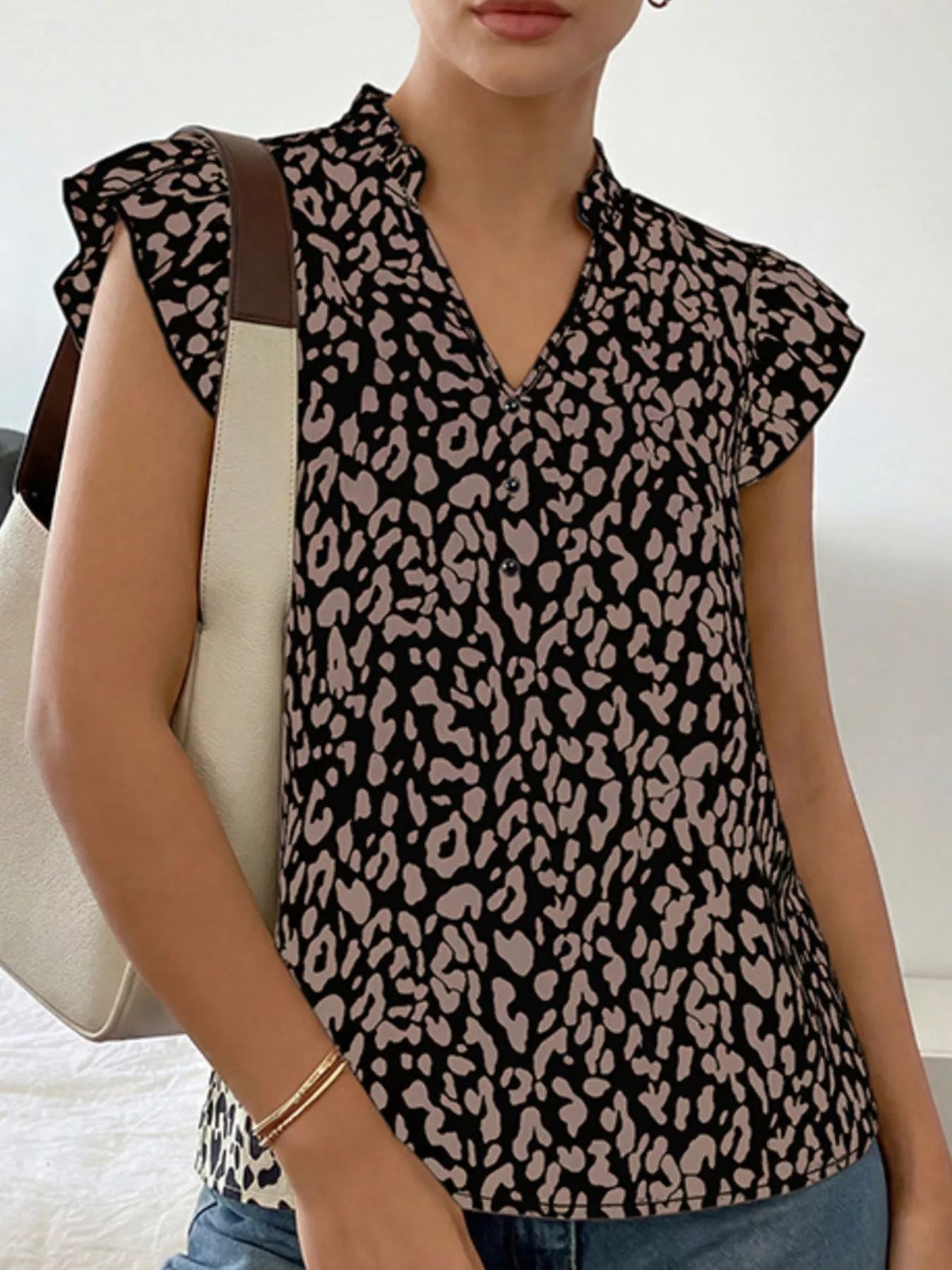 Leopard print ruffle sleeve blouse from Plush Fashion Hub, showcasing stylish design with ruffled sleeves and bold animal print.