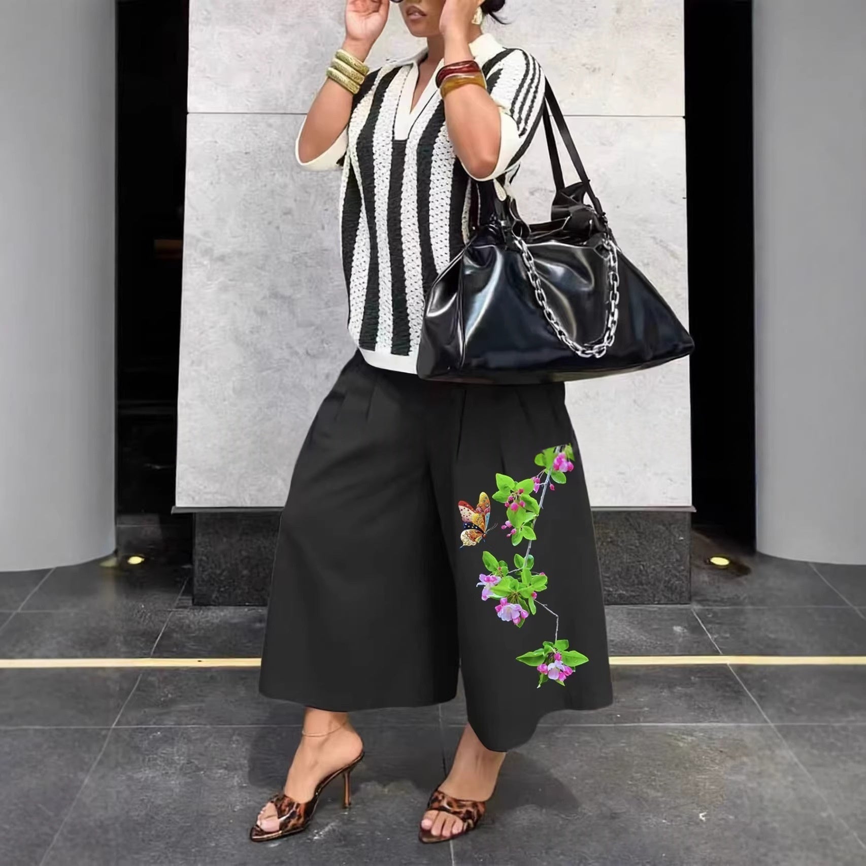 Women's wide-leg cargo pants by Plush Fashion Hub featuring zipper and button details, casual style with practical pockets.