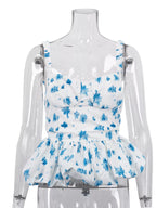 Floral print ruffle hem tank top by Shopimist featuring a sleeveless design and vibrant floral pattern.