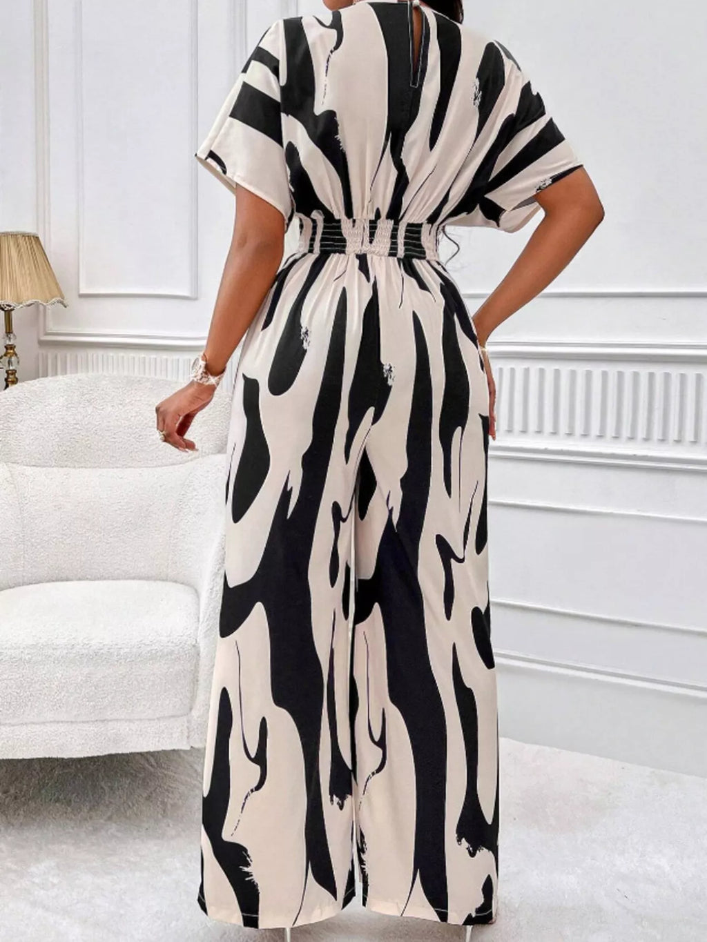 Abstract print wide-leg jumpsuit from Trendsi featuring a stylish, flowing design with a modern, artistic pattern.