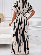 Abstract print wide-leg jumpsuit from Trendsi featuring a stylish, flowing design with a modern, artistic pattern.