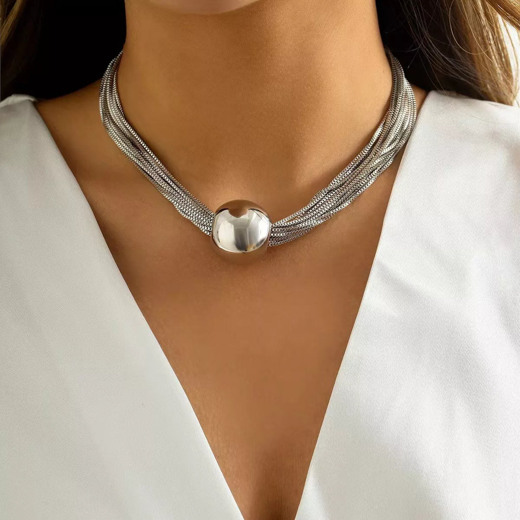Multi-layered adjustable necklace by Shopimist featuring delicate chains and versatile design, displayed on a neutral background.