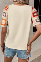 Geometric print round neck short sleeve blouse by Plush Fashion Hub, stylish tops with modern design and vibrant pattern.