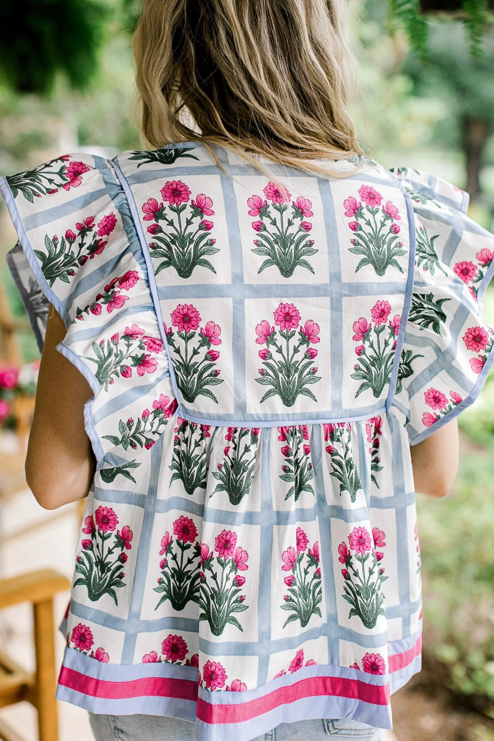Women's floral print ruffle sleeve blouse with lightweight fabric and tied neckline, perfect for casual or dressy occasions.