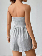 Chic strapless romper with ruched waist, trendy design, and lightweight fabric, perfect for stylish summer wear.