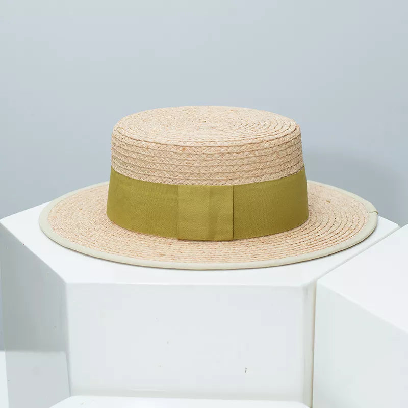 Straw hat with black contrast band, classic boater style, perfect for summer fashion, by Plush Fashion Hub.