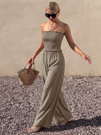 Smocked strapless wide-leg jumpsuit by Plush Fashion Hub, featuring a fitted bodice and flowing pant legs in a stylish design