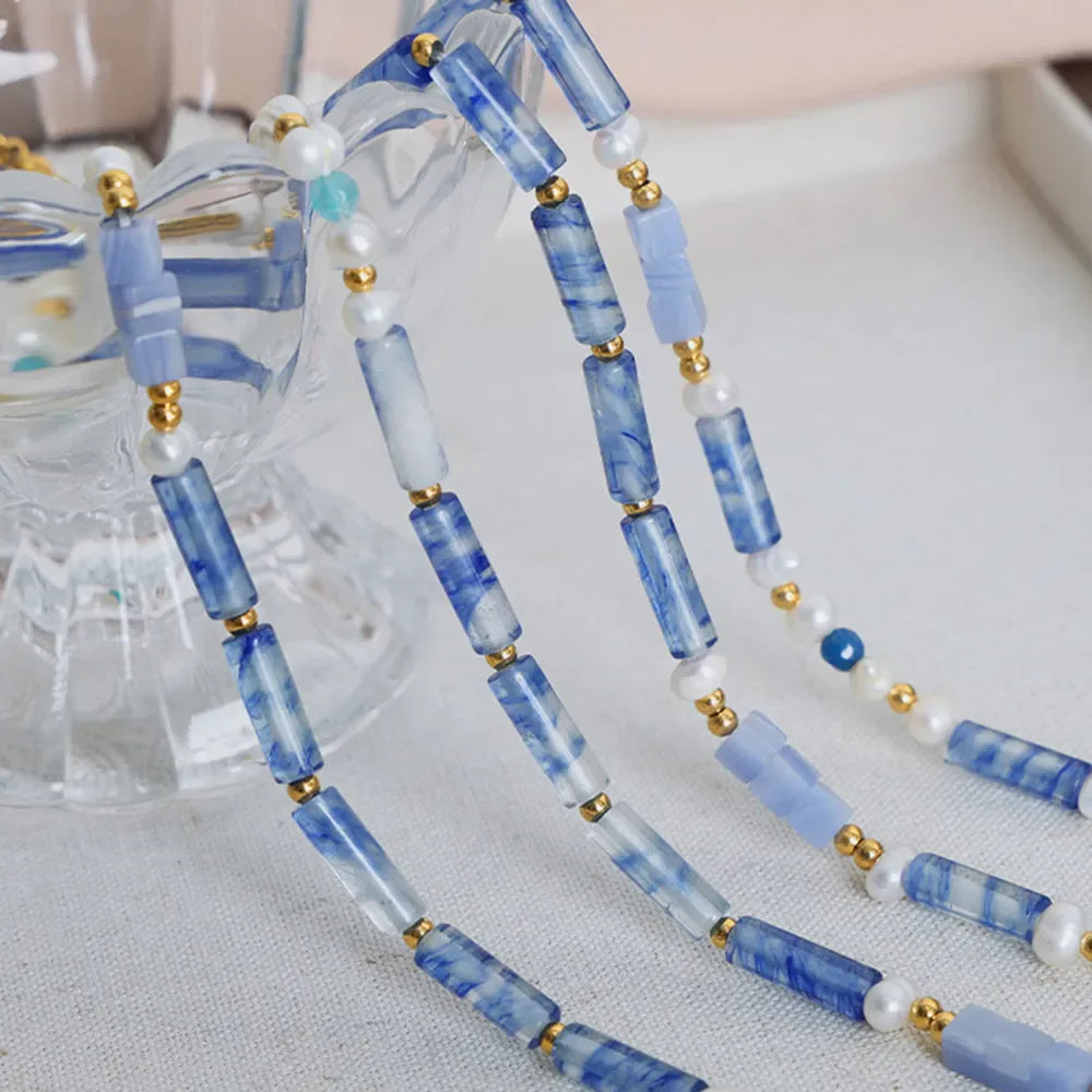 Freshwater pearl and titanium steel geometric bead necklace featuring modern design, with alternating pearl and steel beads.