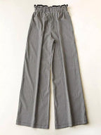 Women's high-waisted gingham wide-leg pants with pockets, trendy fashion pants from Trendsi, shown in black and white checkered pattern.